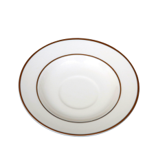 A saucer with decorative gold rings on and near the edge