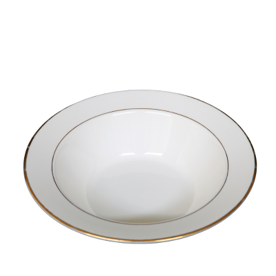A vegetable bowl with decorative gold rings on and near the edge.