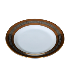 A salad plate with metallic gold and silver rings around the outer edge.