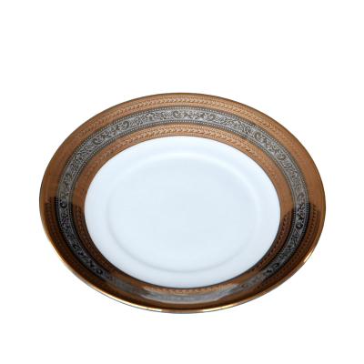 A saucer with metallic gold and silver rings around the outer edge.