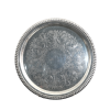 A round serving tray with embossed details.