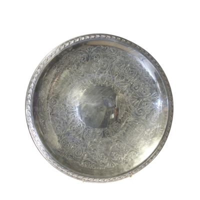 A round serving tray with embossed details.