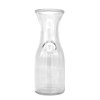 A 0.5 liter wine carafe with a decorative circular design on the front.