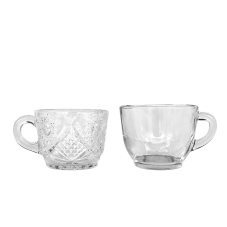 Two punch cups, one plain glass and the other with an etched, ornate pattern.