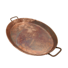 An oval shaped 12 by 18 inch antique copper tray with handles.