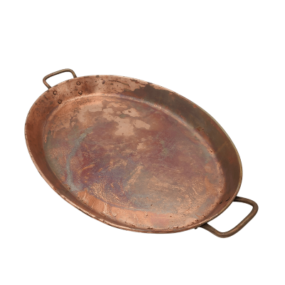 An oval shaped 12 by 18 inch antique copper tray with handles.