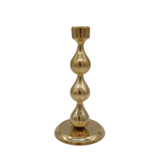 A 6 inch tall candlestick with teardrop-shaped segments in the center.