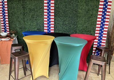 Group of 24-inch high-top tables with spandex linens in sport colors